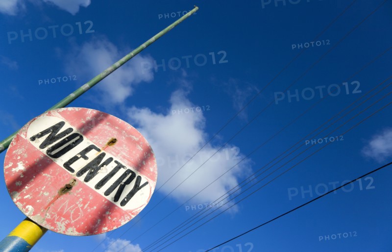 WEST INDIES, St Vincent & The Grenadines, Union Island, Colourful and weather worn No Entry road sign in Clifton.