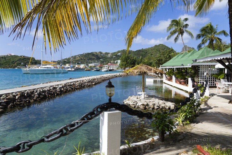 WEST INDIES, St Vincent & The Grenadines, Union Island, The capital of Clifton and the harbour seen from the terrace of the Anchorage Yacht Club restaurant and bar beside the shark pool.