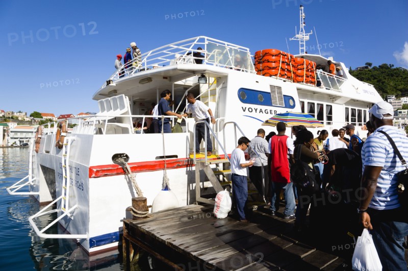WEST INDIES, Grenada, St Georges, The Osprey Shuttle catamaran inter island service in the Carenage with passengers boarding in the morning for Carriacou and Petit Martinique.