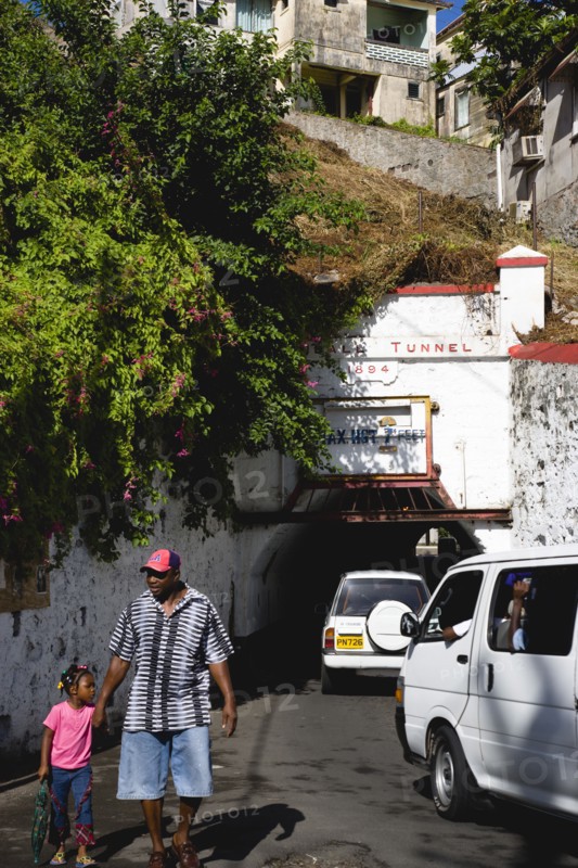 WEST INDIES, Grenada, St Georges, The Sendall Tunnel built in 1894 with pedestrians and cars moving through it.