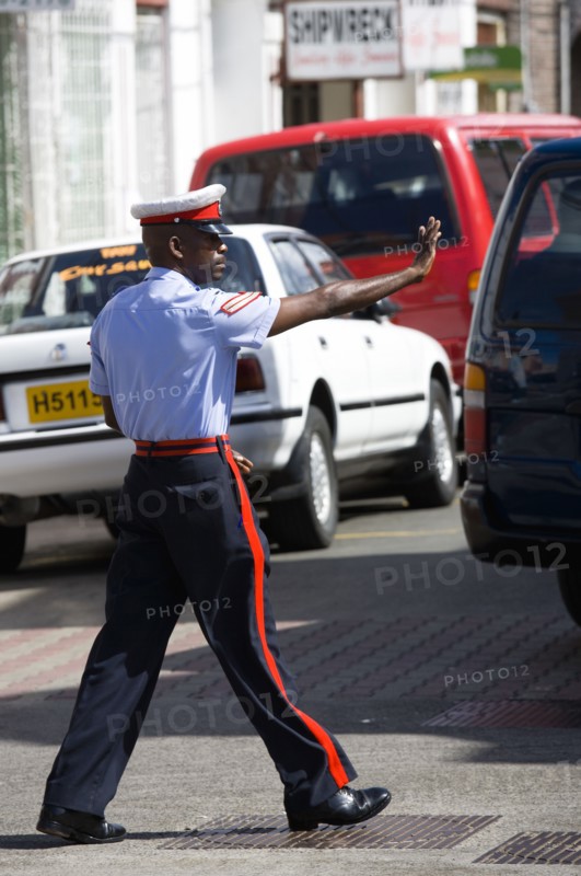 WEST INDIES, Grenada, St Georges, Corporal in the Royal Granada Police Force directing traffic at rush hour in the capital.