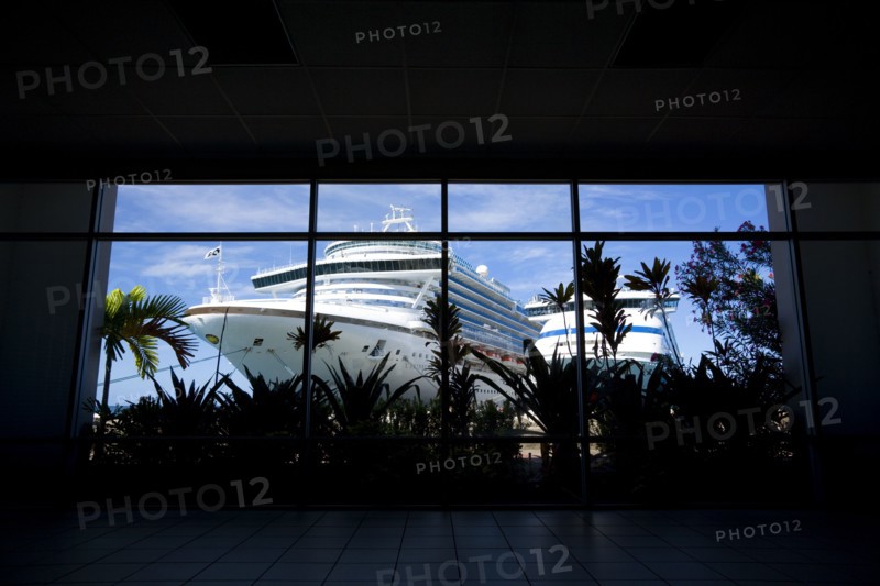 WEST INDIES, Grenada, St George, The cruise ship liners Caribbean Princess and Aida Aura docked at the Cruise Ship Terminal in the capital St Georges seen through the window of the ternminal building.
