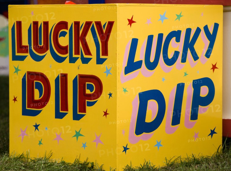 ENGLAND, West Sussex, Findon, Findon village Sheep Fair Colourful yellow sign for a Lucky Dip fairground stall.