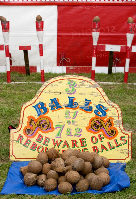 ENGLAND, West Sussex, Findon, Findon village Sheep Fair Coconut shy with sign reading Beware of Rebounding Balls.