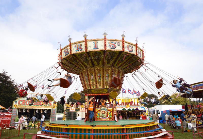 ENGLAND, West Sussex, Findon, Findon village Sheep Fair Children in motion riding on a swing carousel.