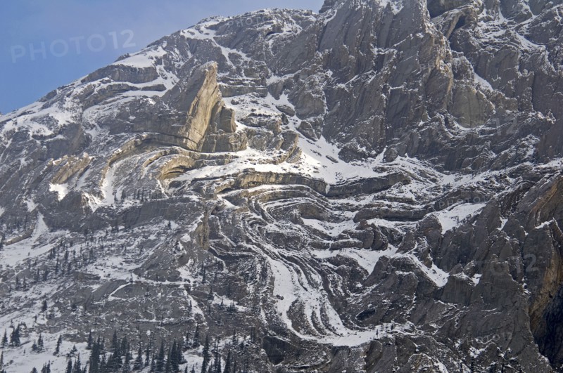 CANADA, Alberta , Kananaskis, A light sprinkling of snow makes it easier to see the complex rock formation of the south face of Mount Evan Thomas.
