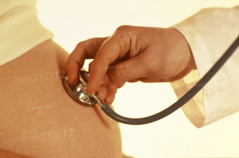 MEDICAL, Health, Pregnancy, Cropped view of doctor using stethoscope to examine pregnant woman.