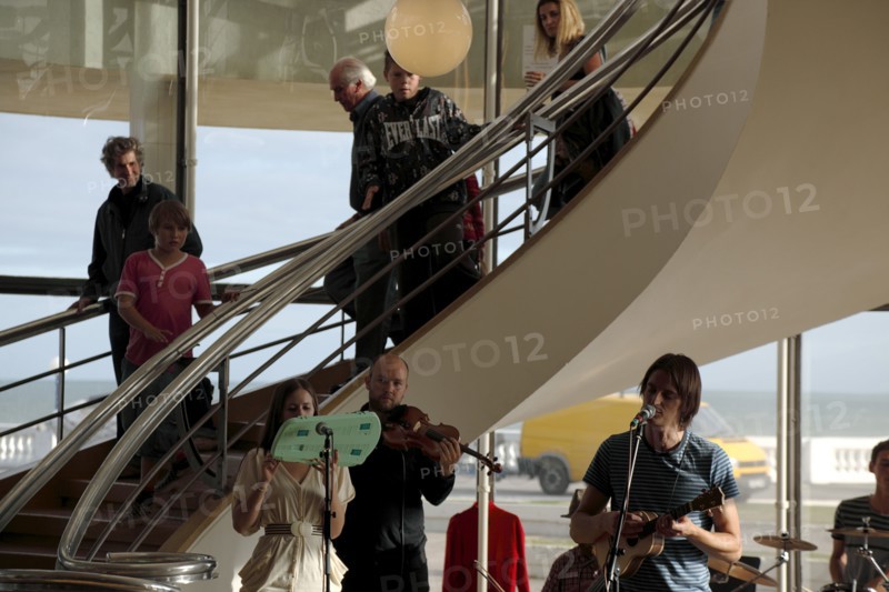 ENGLAND, East Sussex, Bexhill on Sea, De La Warr pavilion. Art Deco style building housing art gallery and theatre. Band performance under the stairwell from the Wilkomen Collective group including the Leisure Society.
