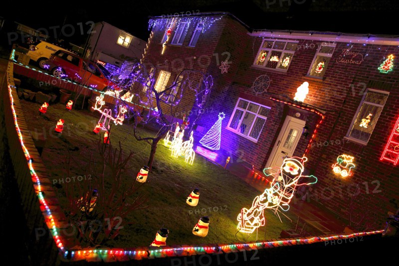 ENGLAND, West Sussex, Southwick, Cul de Sac of houses decorated with fairy lights for Christmas.