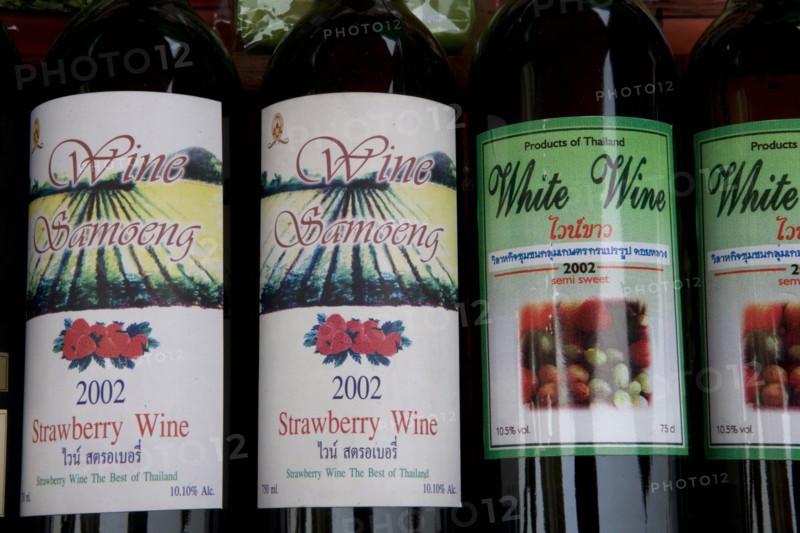 THAILAND, North, Chiang Mai, Samoeng. Close up of locally produced strawberry wine bottle labels.