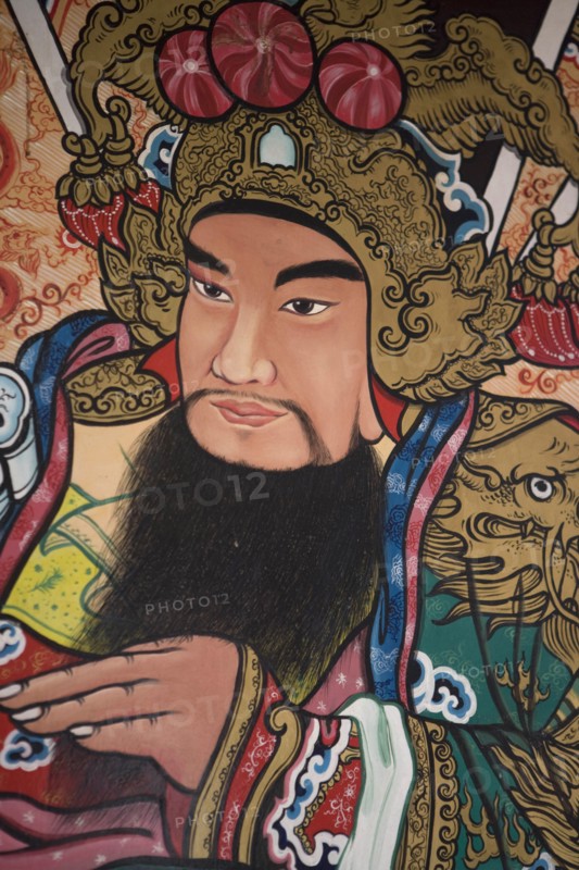 THAILAND, North, Chiang Mai, Pung Tao Gong Ancestral Temple. Close up of a colourful mural depicting a male deity.