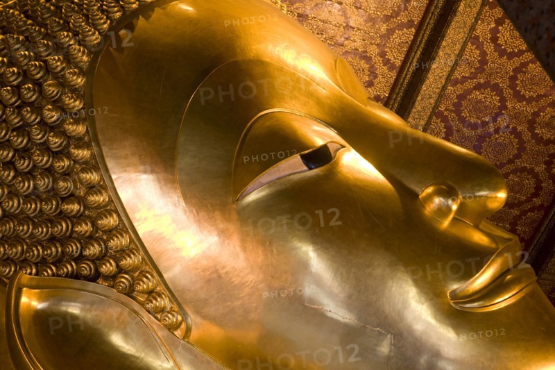 THAILAND, Central, Bangkok, Wat Pho also known as Wat Phra Chetuphon. Close up of the face of the large reclining buddha statue.