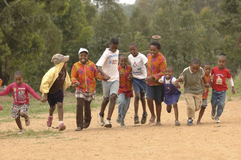 AFRICA, Children , Playing, School Children running on dirt road.
