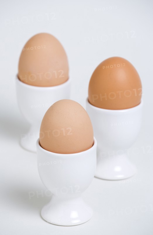 FOOD, Uncooked, Eggs, Three boiled free range eggs in egg cups.