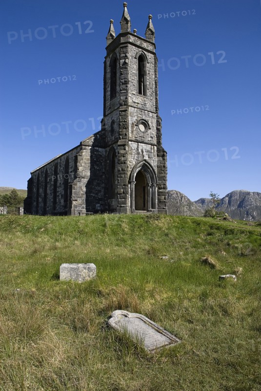 IRELAND, County Doneghal, Poisoned Glen, Ruined Church of Ireland building with gravestone in foreground.