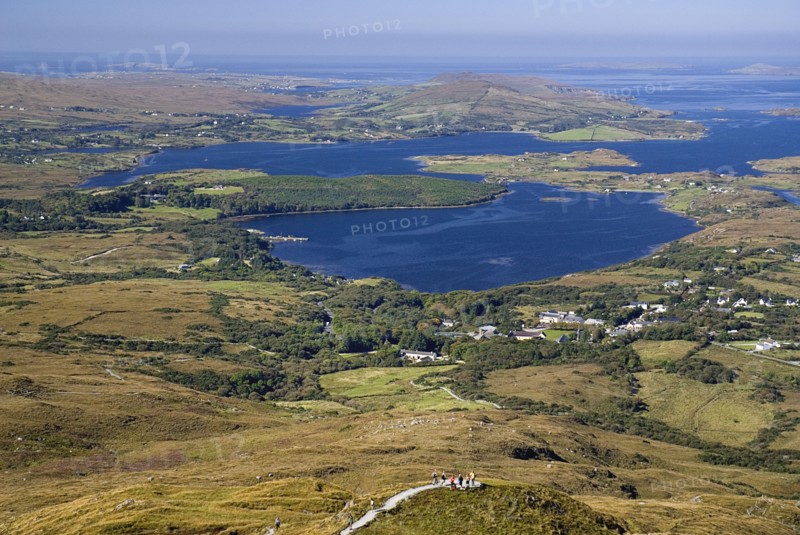 IRELAND, County Galway, Connemara, Diamond Hill, Ballynakill Harbour as seen from the slopes of the hill  Hikers at viewpoint.