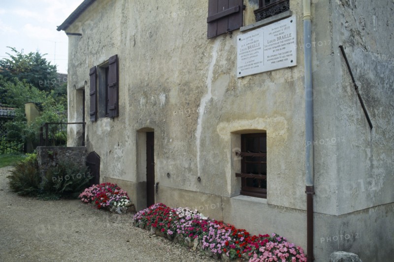 France, Ile de France, Coupvray, Marble commemorative plaque under a shuttered window on the wall of the house where Louis Braille lived in the commune.