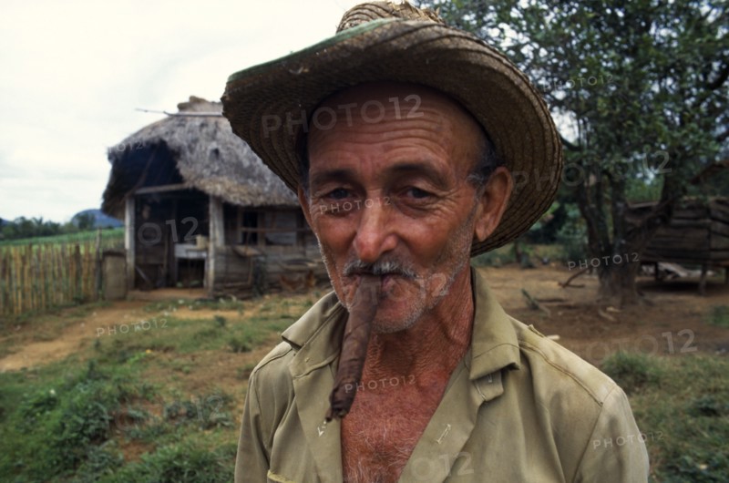 CUBA, Vinales, Pinar del Rio, Portrait of tobacco farmer smoking cigar.