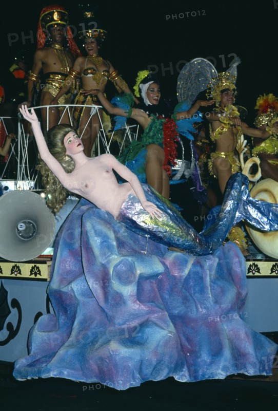 Cuba, Matanzas, Varadero, Carnival float decorated with a papier mache mermaid with people in costume dancing on the float.