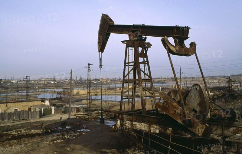 Azerbijan, Polluted wasteland with nodding donkey of oil field near Baku.