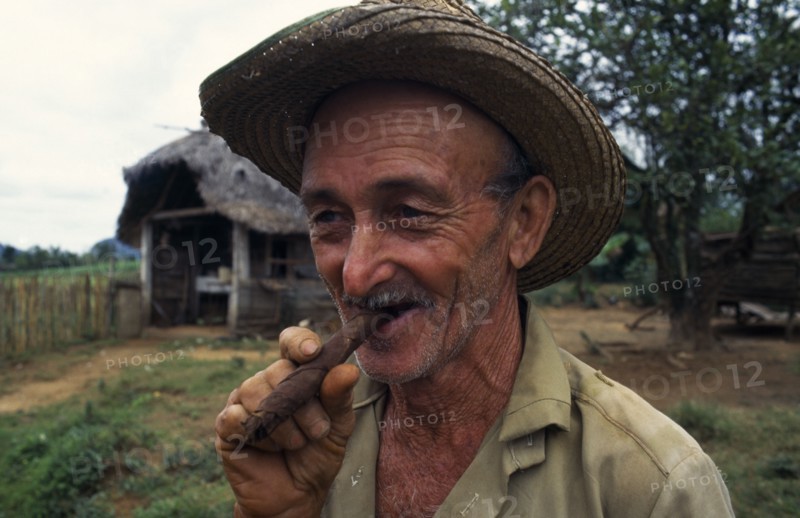 CUBA, Vinales, Portrait of tobacco planter smoking cigar.