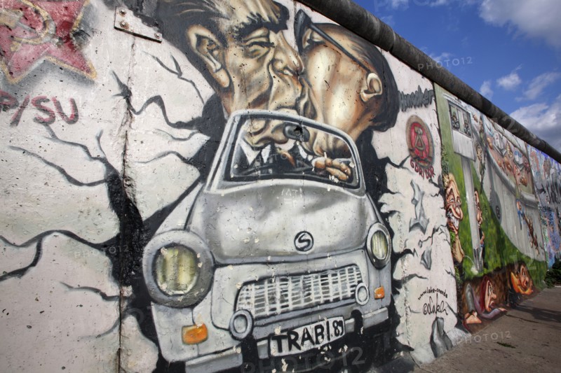 Germany, Berlin, Mural of Erich Honecker & Leonid Brezhnev kissing in a car, East Side Gallery, Berlin Wall.