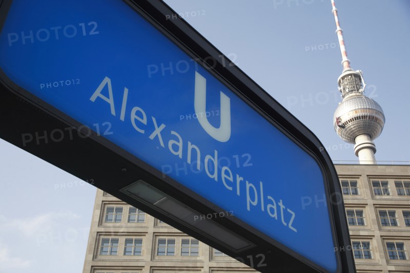 Germany, Berlin, Alexanderplatz, U Bahn sign for Alexanderplatz with Fernsehturm & office building in background.