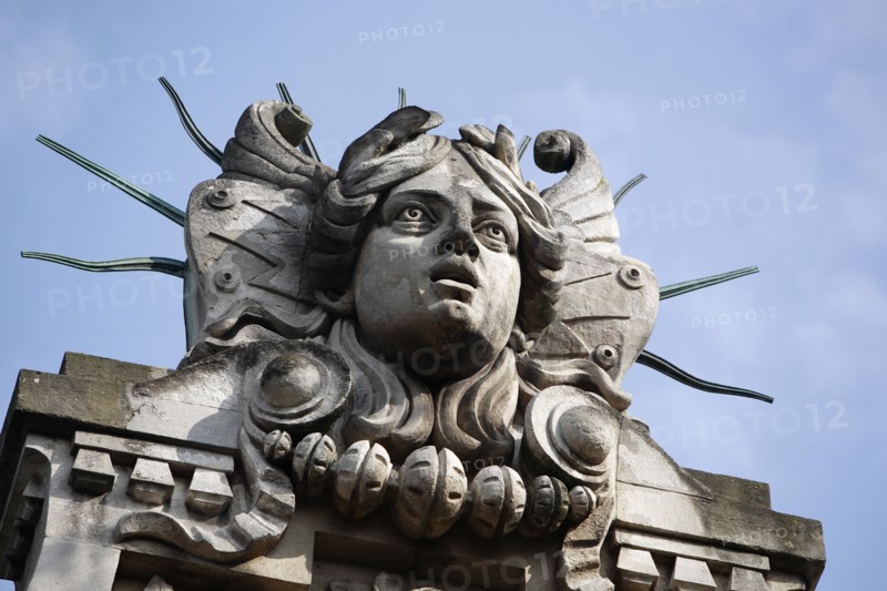 Poland, Krakow, Head of Apollo on top of the entrance to the Palace of Arts built in 1901 for the Society of Fine Arts Friends.