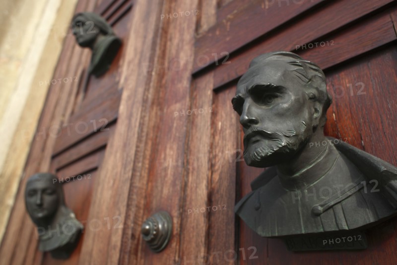Poland, Krakow, busts on the doors of the Mariacki Basilica or Church of St Mary.