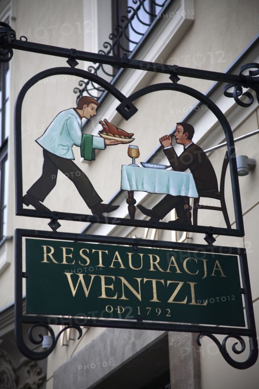 Poland, Krakow, sign for Restaurant Wentzl in the old city.