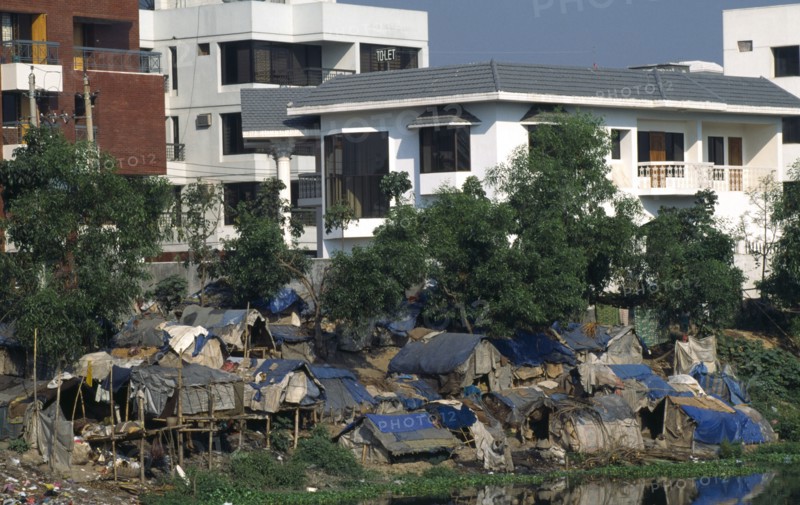Bangladesh, Dhaka, Slum dwellings with expensive apartments behind.
