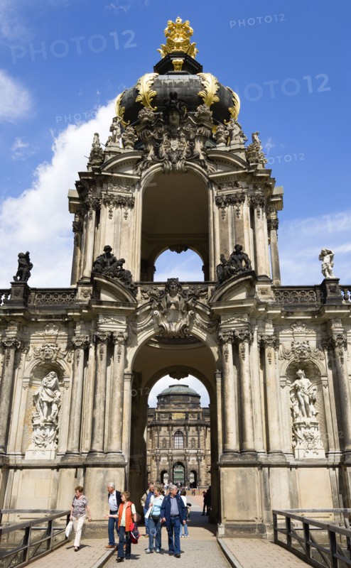 GERMANY, Saxony, Dresden, The Crown Gate or Kronentor of the restored Baroque Zwinger Palace with tourists walking through originally built between 1710 and 1732 after a design by Matthäus Daniel Pöppelmann in collaboration with sculptor Balthasar Permoser.
