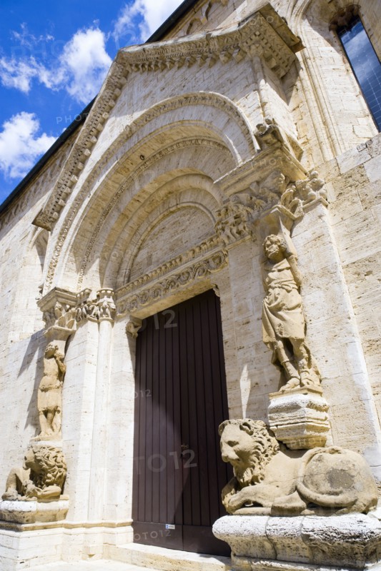 ITALY, Tuscany, San Quirico D'Orcia, The columns of the portale di mezzogiorno or southern door of the Collegiata the Church of the saints Quirico and Giulitta attributed to the school of Giovanni Pisano showing a men above caryatid or zoomorphic statues of reclining lions.