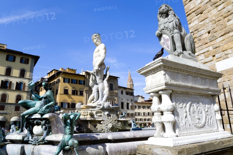 ITALY, Tuscany, Florence, The 1575 Mannerist Neptune fountain with the Roman sea God surrounded by water nymphs commemorating Tuscan naval victories by Ammannatti in the Piazza della Signoria beside the Palazzo Vecchio.