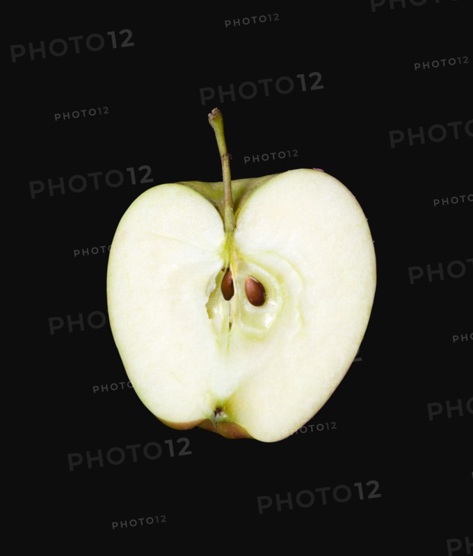 Food, Fruit, Apples, One single ripe green apple cut in half against a black background showing the core and seeds.
