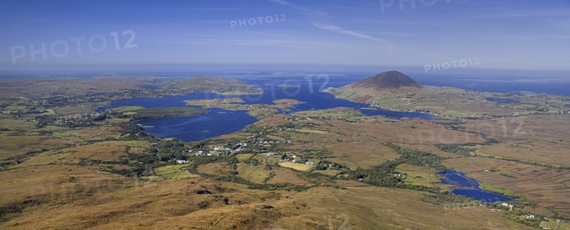IRELAND, County Galway, Connemara, Diamond Hill,  Ballynakill Harbour as seen from the slopes of the hill  Hikers at viewpoint.