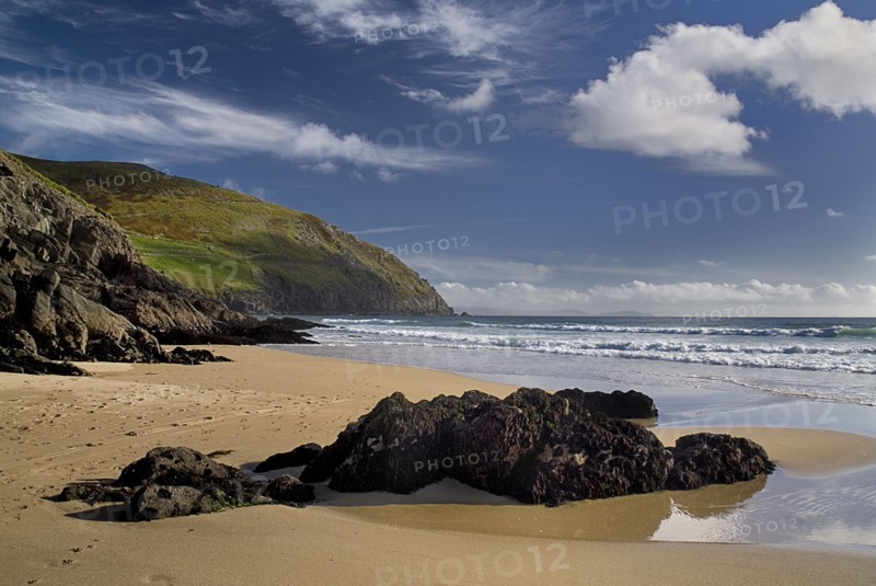 IRELAND, County Kerry, Dingle Peninsula, Coumeenole Beach at Slea Head  Incoming waves with rocks on shoreline.