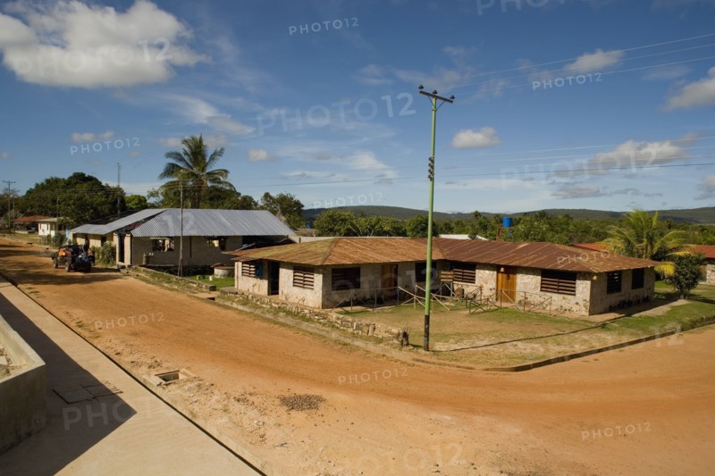 VENEZUELA, Bolivar State, Canaima National Park, Canaima Village, View of the main street junction of Canaima village known as the gateway to Angel Falls , shoot from a height level on a bright day with blue sky and white clouds.