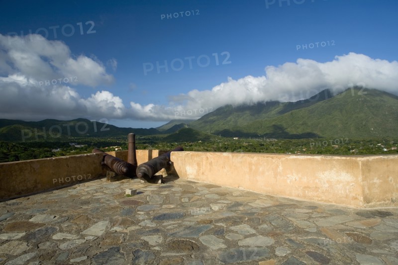 VENEZUELA, Margarita Island, La Asuncion, Canons at the terrace of Castillo de Santa Rosa fort facing the valley and the La Asuncion small town.
