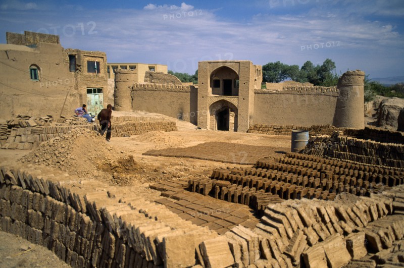 Iran, Yazd Province, Meybod, Mud brick making in ancient mud city.