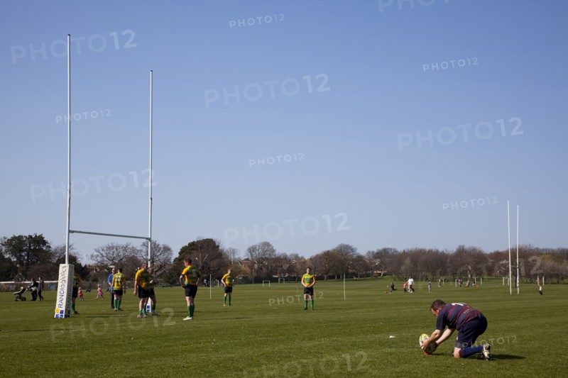 England, West Sussex, Shoreham-by-Sea, Rugby Teams playing on Victoria Park playing fields. Player placing ball to attempt to kick a conversion.