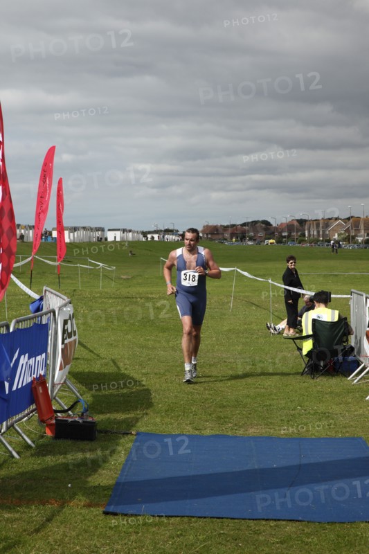 England, West Sussex, Goring-by-Sea, Worthing Triathlon 2009, male competitor approaching finish line.