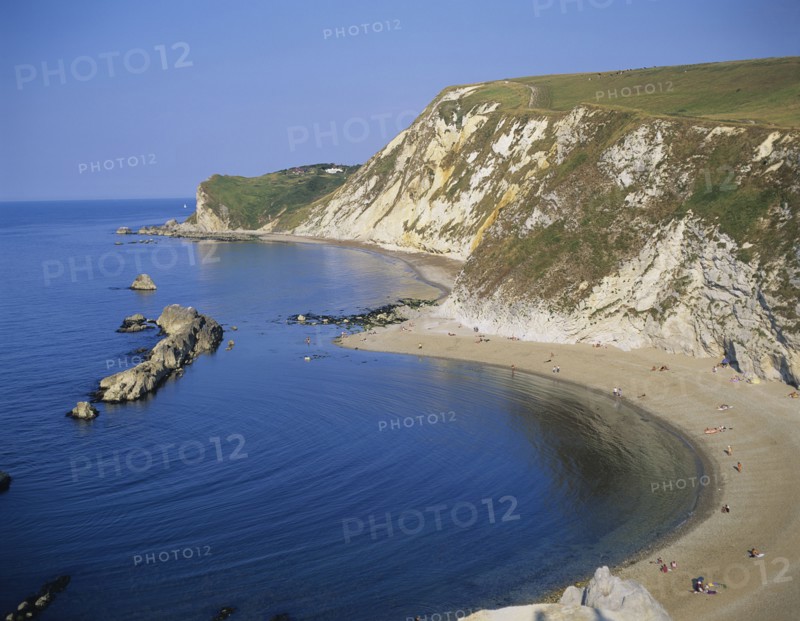 England, Dorset, Typical rocky coastline and sandy bay.