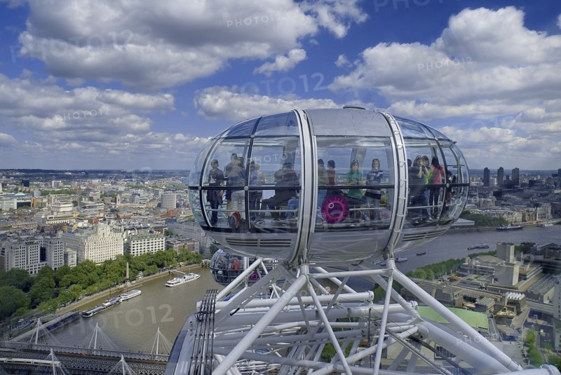 England, London, Southbank, London Eye capsule with passengers visible in capsule with the City in the background.