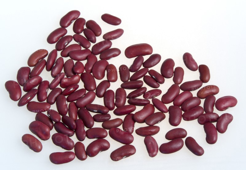 Food, Uncooked, Beans, Red kidney beans scattered on a white surface.