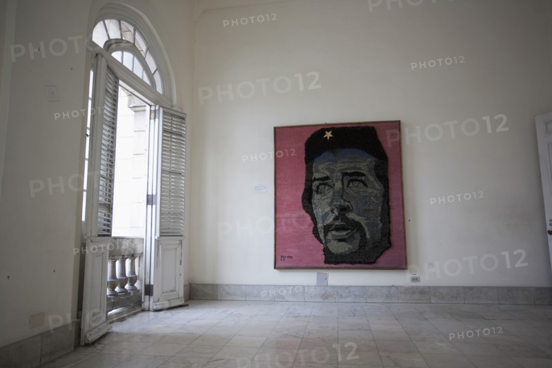 Cuba, Havana, Centro Habana, Refugio 1, exhibition room at the museum of the revolution with a colored painting on the wall inspired by Fidel Castro.