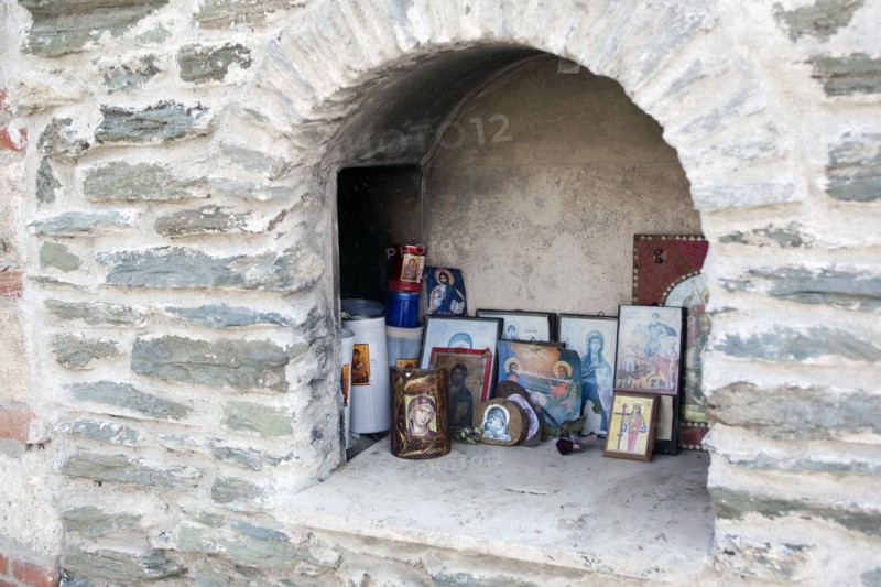 Greece, Macedonia, Thessaloniki, Greek Christian Orthodox religious icons inside a small iconostasis within Moni Vlatadon monastery stone walls