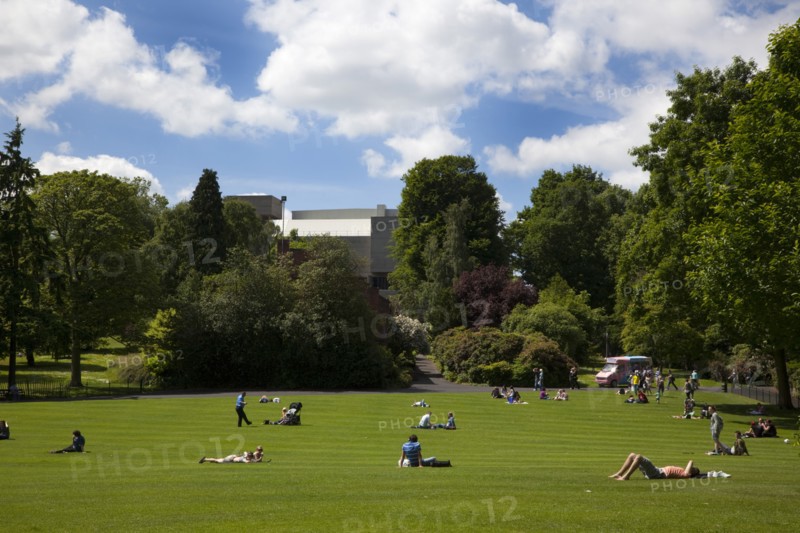 Ireland, North, Belfast, Botanic Gardens with people relaxing in the sun.