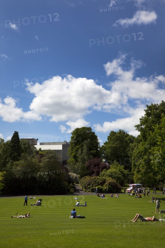 Ireland, North, Belfast, Botanic Gardens with people relaxing in the sun.