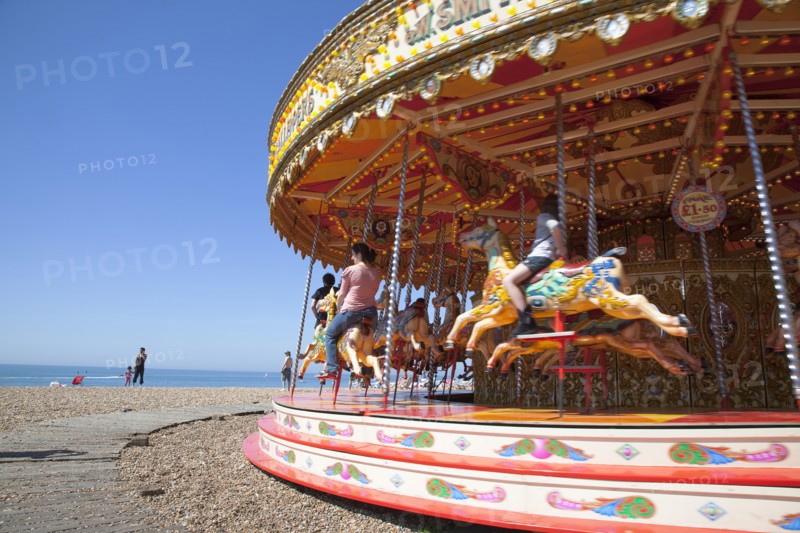 England, East Sussex, Brighton, Carousel on the pebble beach promenade.